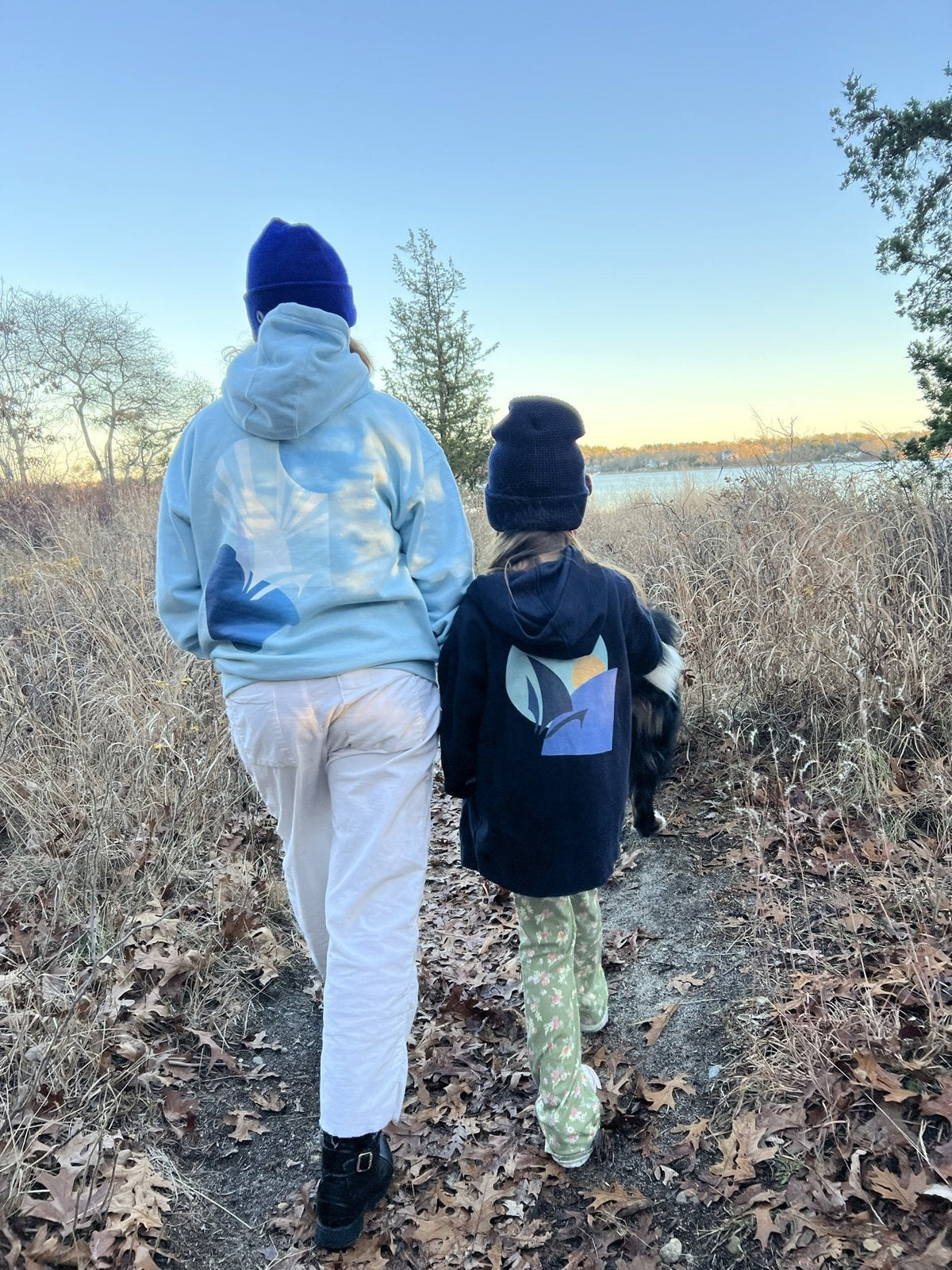 Daring Blues Fleece Premium Hoodie in Sky Blue, back view walking to the lake (real photo)
