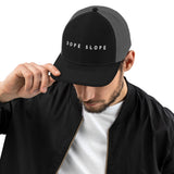 Après Ski Dope Slope Night Trucker Cap in Black/Charcoal, front view on model
