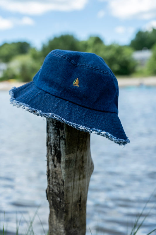 Inspired Sailer Distressed Denim Bucket Hat worn on a wooden post (real photo)