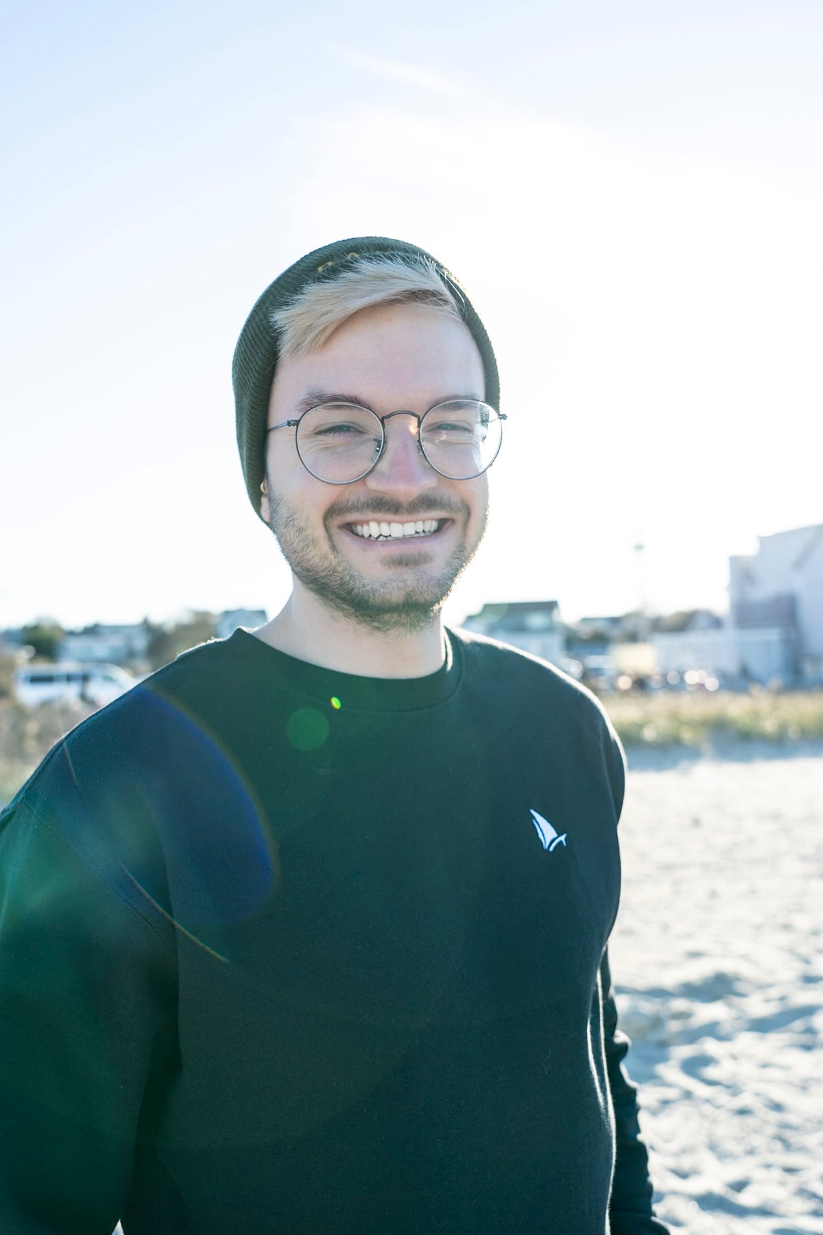 Classic Sailer Crewneck Sweatshirt in black, man smiling on the beach
