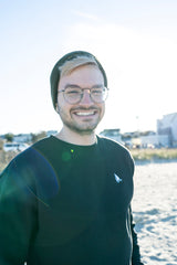 Classic Sailer Crewneck Sweatshirt in black, man smiling on the beach