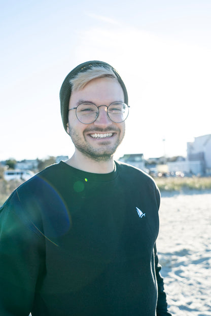 Classic Sailer Crewneck Sweatshirt in black, man smiling on the beach