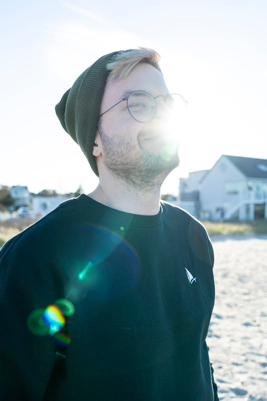 Classic Sailer Crewneck Sweatshirt in black, sun flare beach portrait