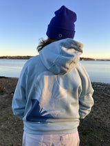 Daring Blues Fleece Premium Hoodie in Sky Blue, back view worn with a royal blue beanie (real photo)