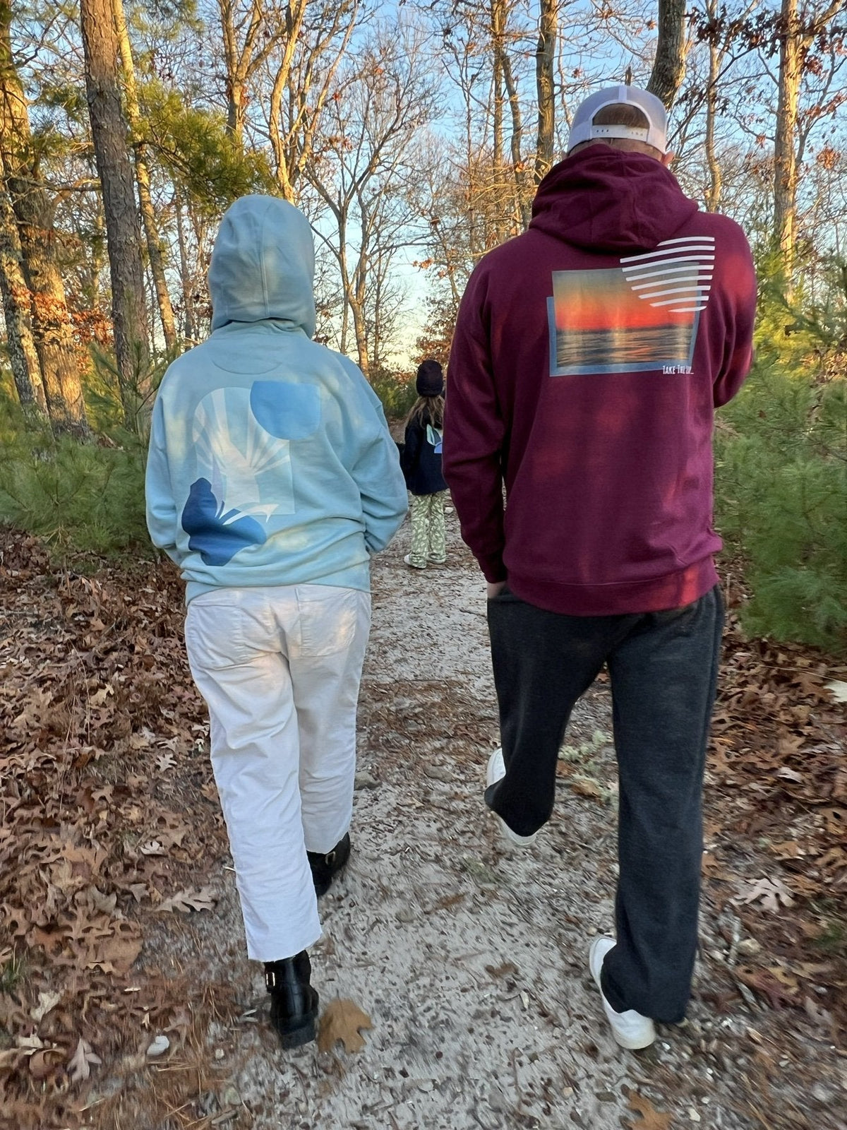Daring Blues Fleece Premium Hoodie in Sky Blue, back view walking a sandy trail (real photo)