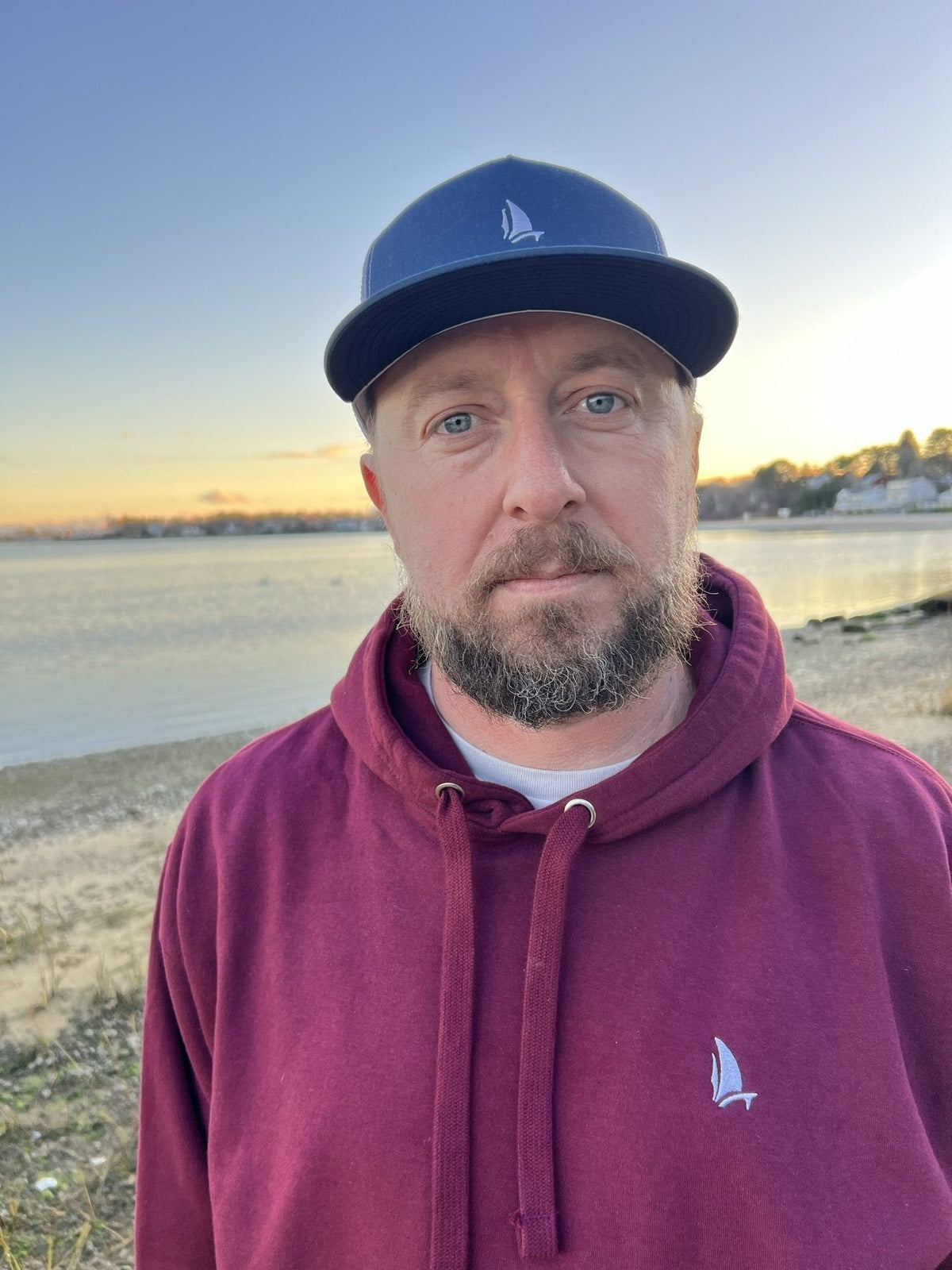 Classic Trucker Straight Cap in Navy, front view worn with Take The Leap hoodie (real photo)